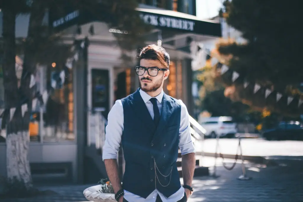 Man standing on the corner in a suit.